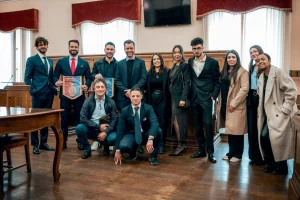 Fotografia colorida mostrando várias pessoas posando para foto em sala de reunião-Metrópoles